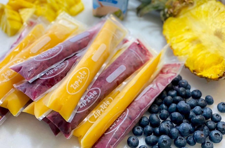 various purple and orange popsicles laying on countertop