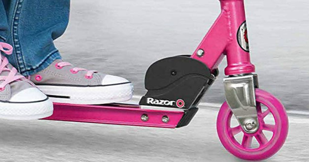 close up of girl's feet on a pink Razor scooter