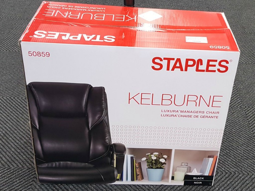 box with office chair in it on store floor