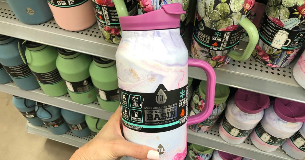 stainless steel jug being held in front of store shelf