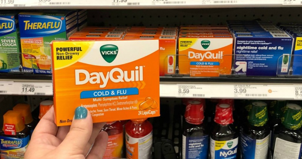 hand holding dayquil liquicaps at target