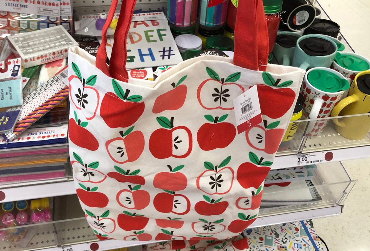 apple print tote bag in front of a store shelf