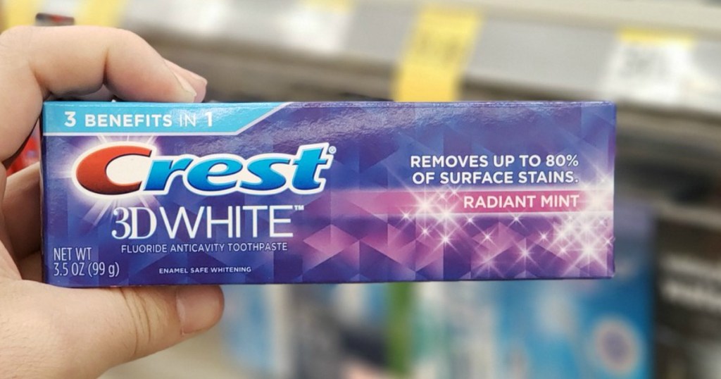 hand holding crest toothpaste at walgreens