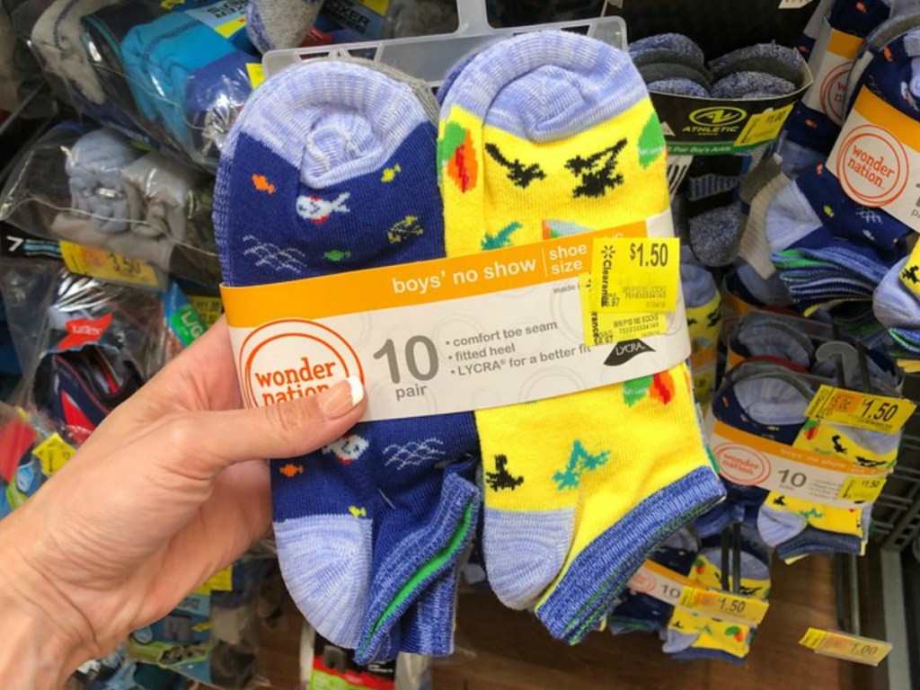 hand holding colorful pairs of boys socks in store