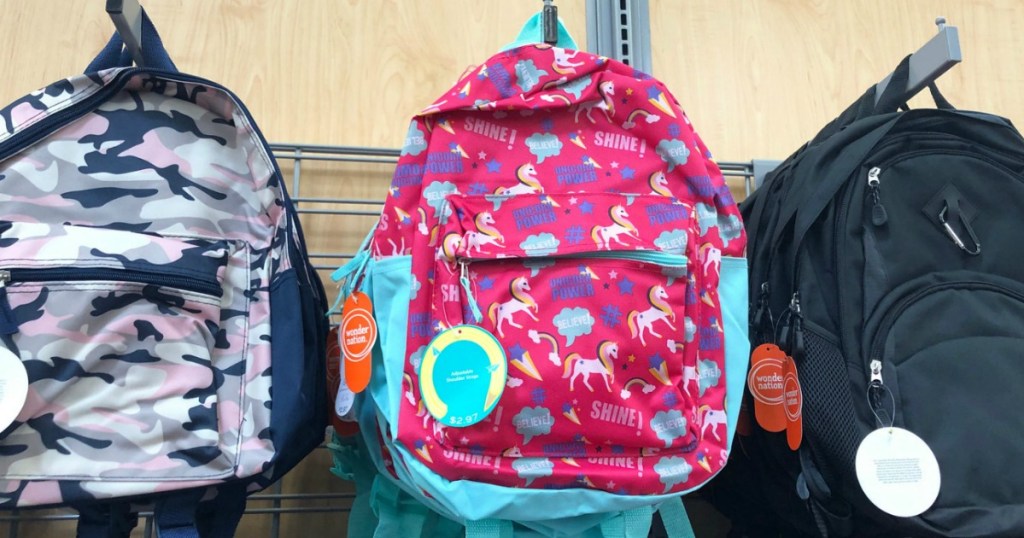 store display with three backpacks hanging