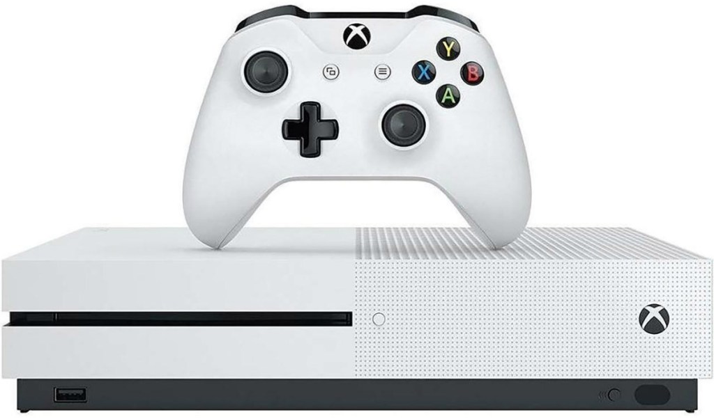 white gaming console with white controller on top