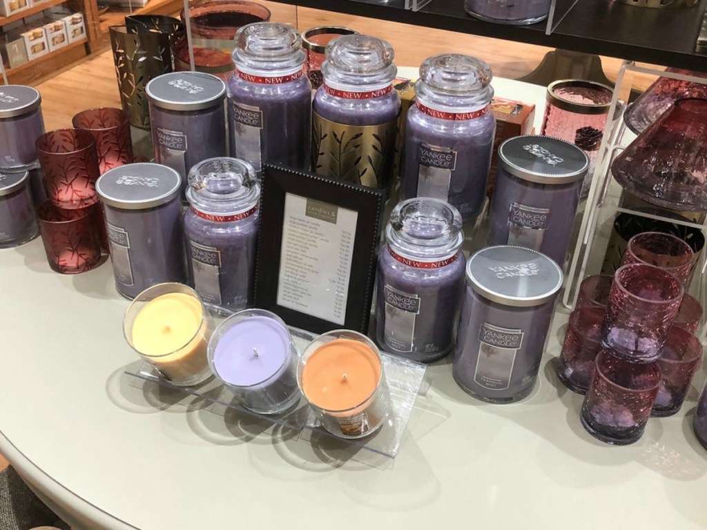 a bunch of candles sitting on table in store