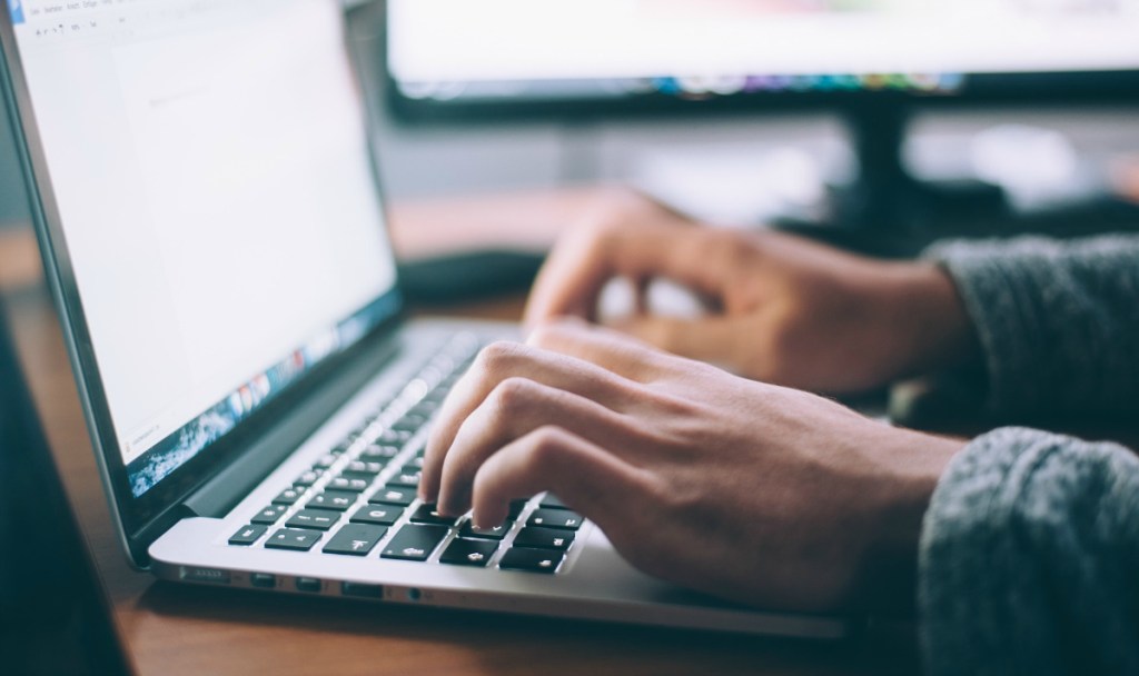 person typing on laptop