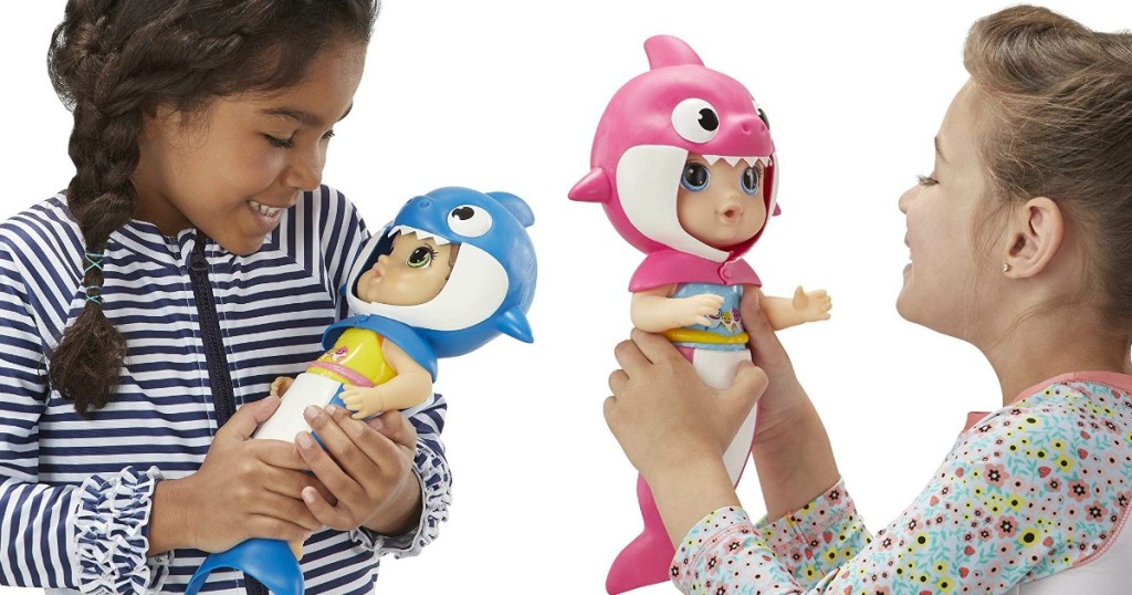 girls holding Baby Alive Baby Shark dolls