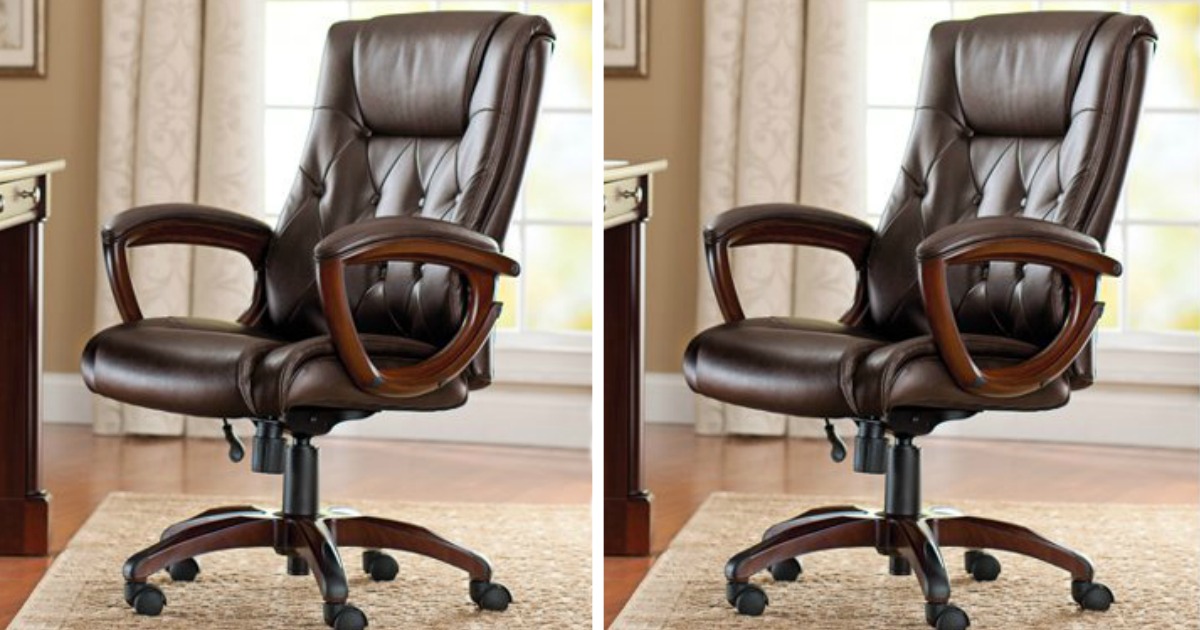 two brown leather office chairs sitting in a home office