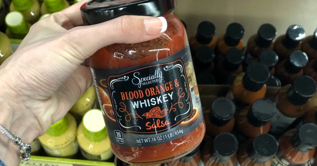 Woman holding Blood Orange & Whiskey Salsa ALDI