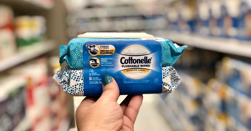 woman holding up cottonelle flushable wipes