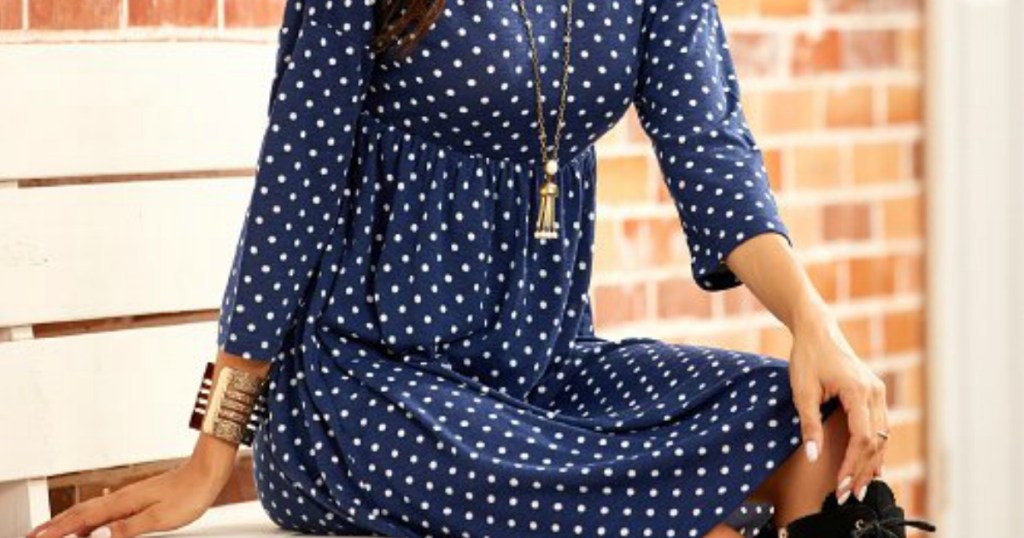 lady sitting in a blue and white polka dot fall dress