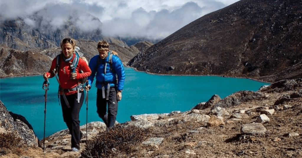 Eddie Bauer Man and woman Hiking with lake in background