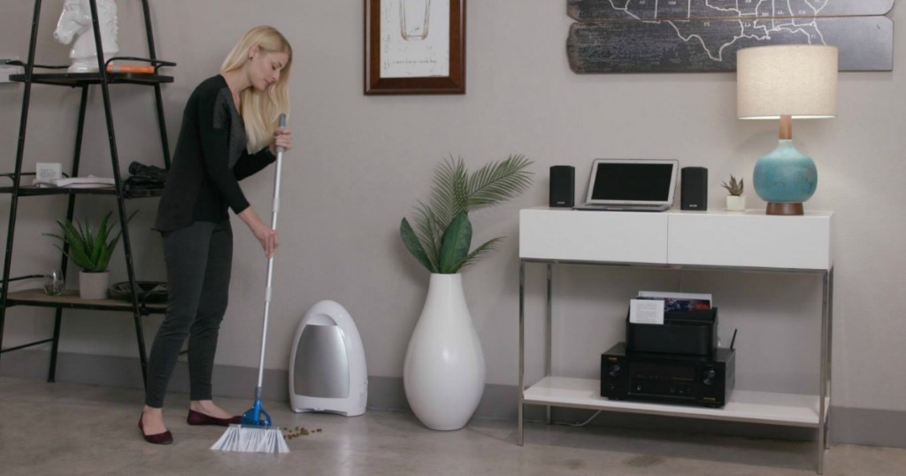 person sweeping next to vacuum