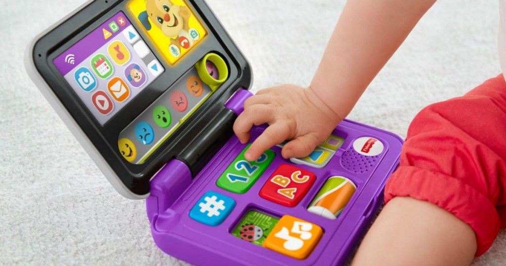 closeup of child playing with a Fisher-Price toy laptop