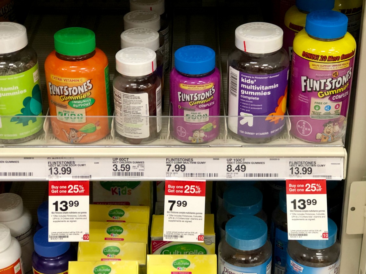 collection of Flintstones and up & up vitamins on a Target store shelf