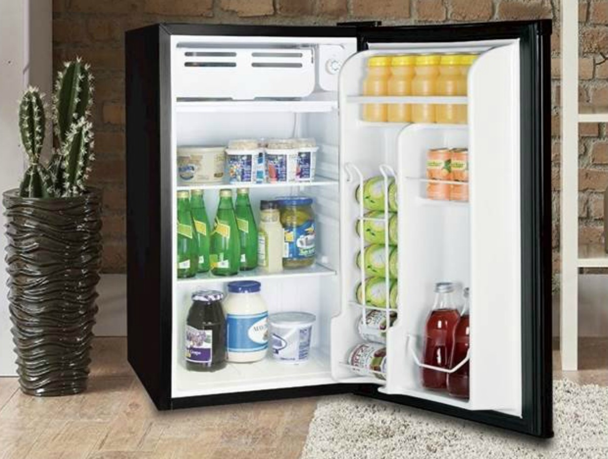 black mini fridge with open door and displayed contents