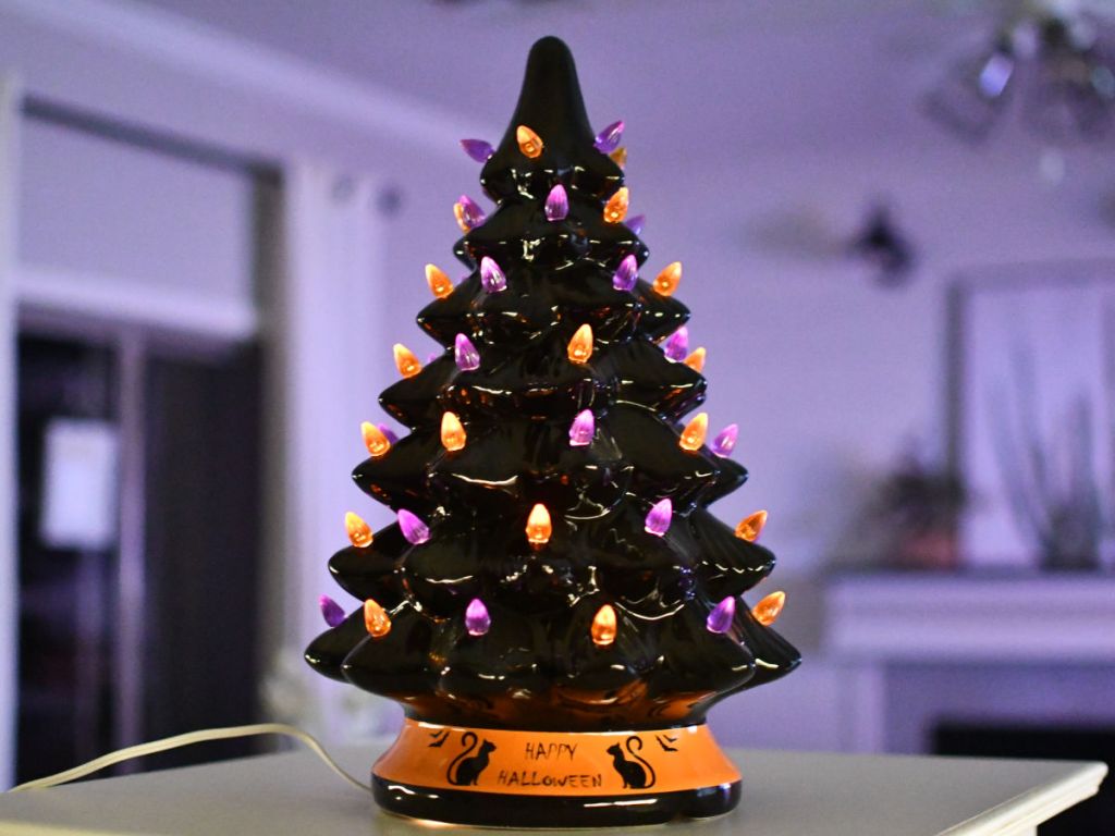 Lit up Halloween Tree in room with purple lighting