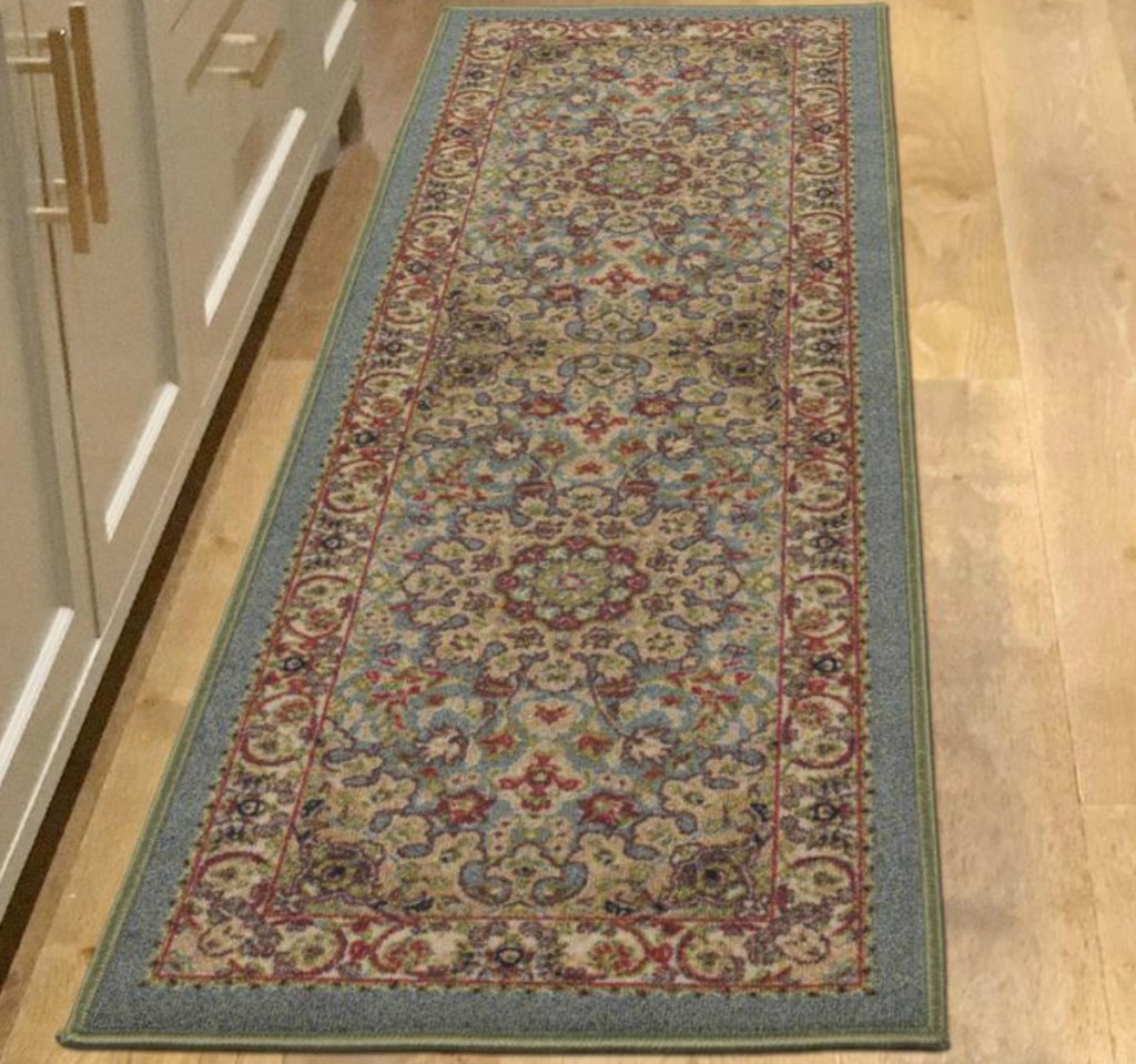 Green medallion print area rug runner-style from Home Depot on hardwood floors