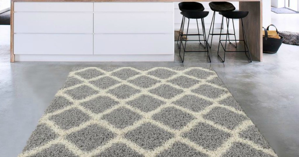 Gray and White Area Rug on gray kitchen floor near counter with black stools