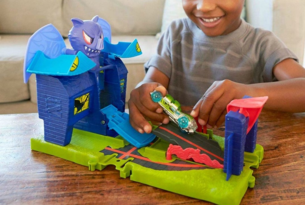 boy playing with hot wheels bat manor set