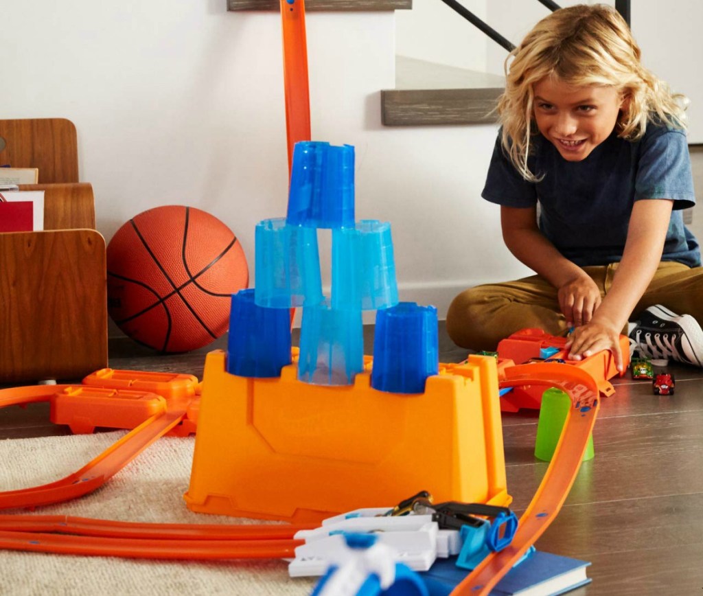 Boy playing with the Hot Wheel Barrel set