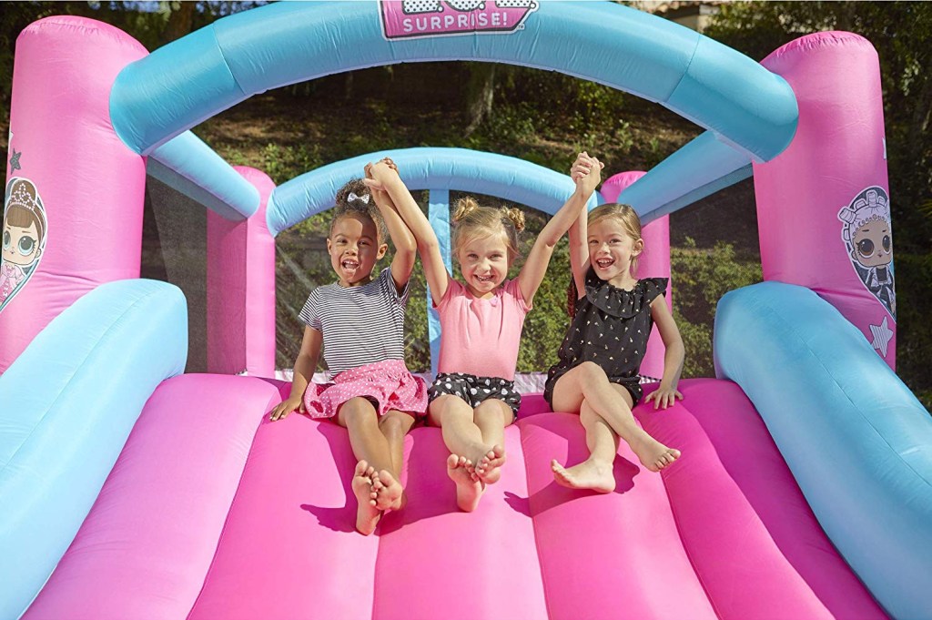 girls sliding down slide on LOL Surprise Bounce House