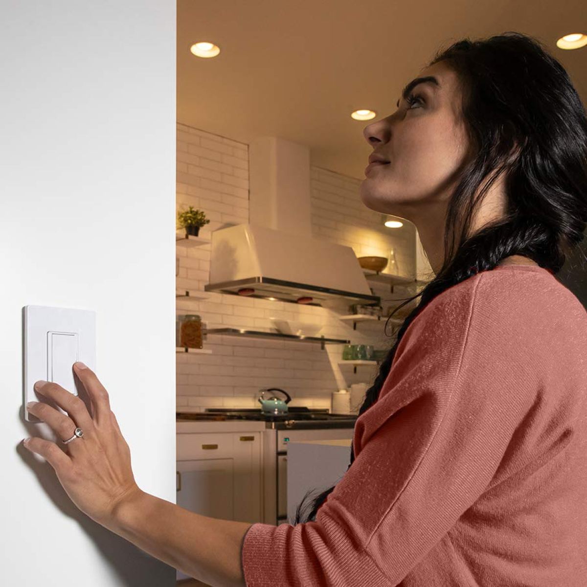 woman turning on light with switch