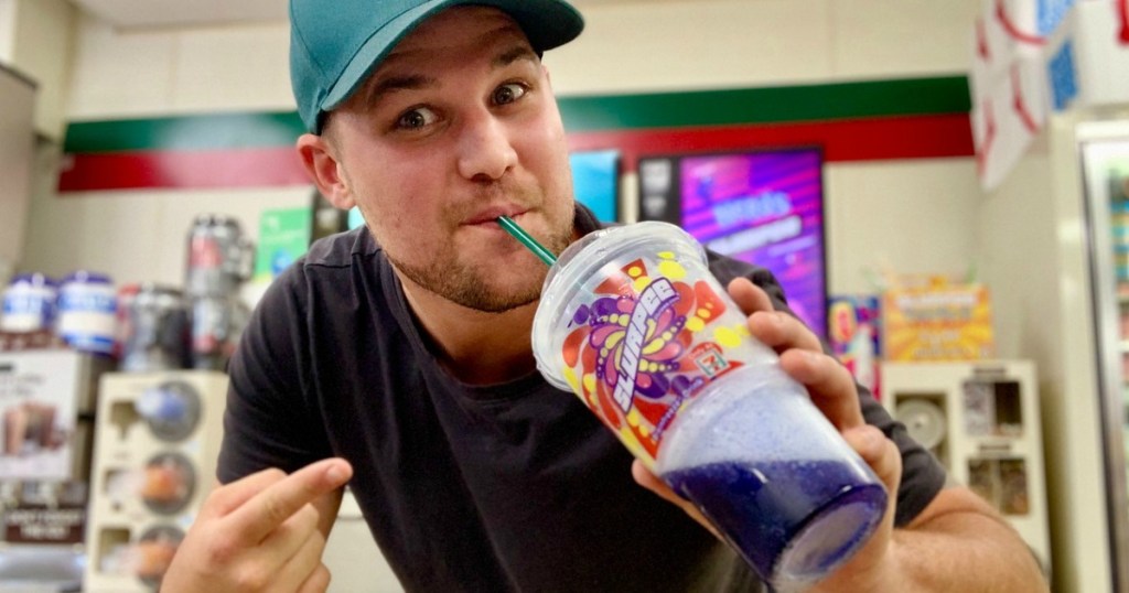 man drinking purple slurpee