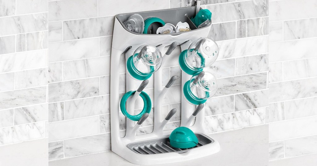 OXO Tot Space-Saving Drying Rack against a white tile wall