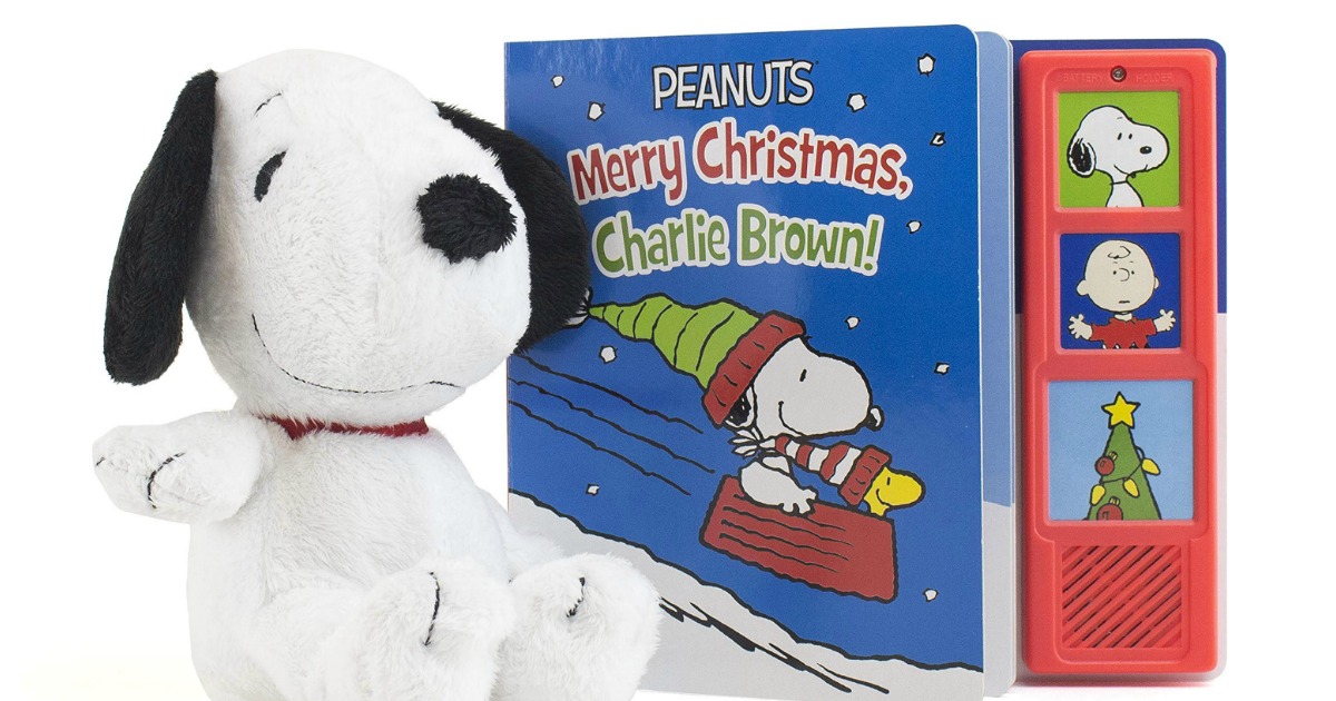 snoopy plush toy next to a Merry Christmas Charlie Brown book