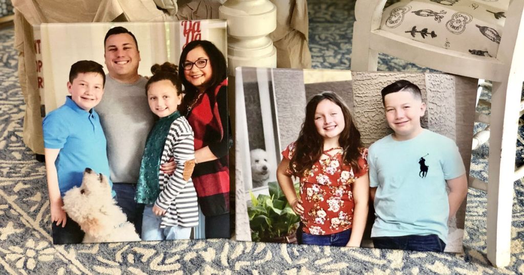 Linas family in two photo canvases leaned up against table