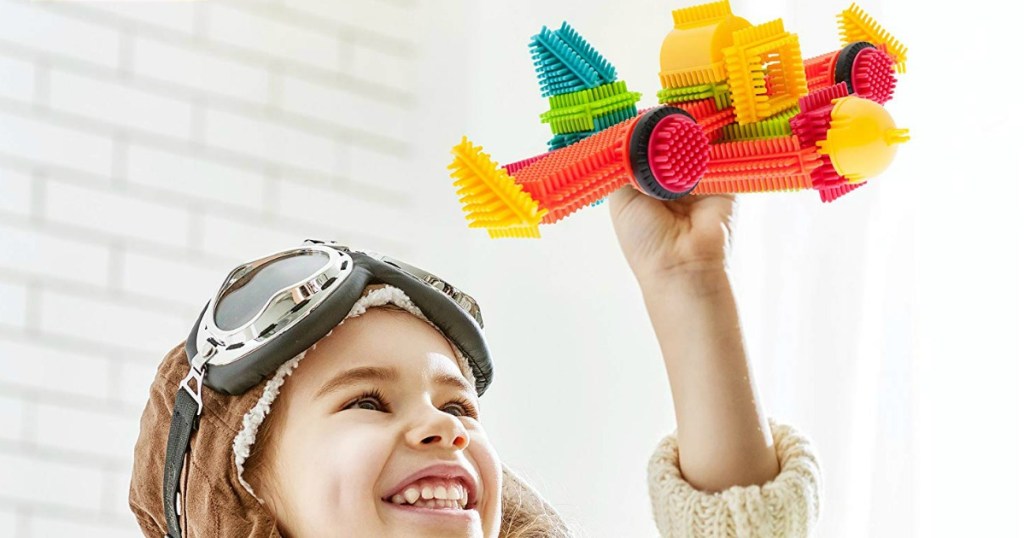 boy playing with Bristle Blocks plane