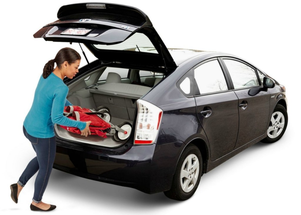 woman putting foldable wagon into the back of a car