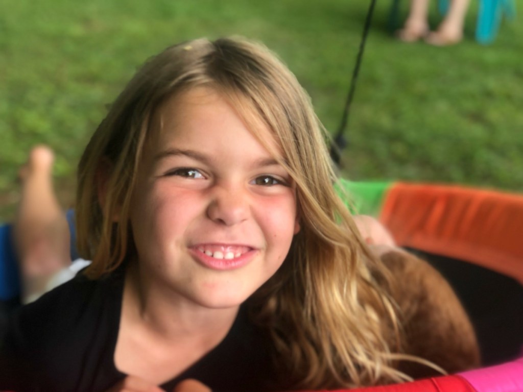 little girl on a saucer swing