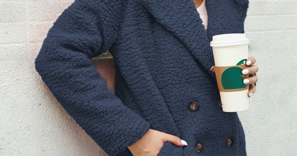 lady holding a coffee and wearing a sherpa jacket