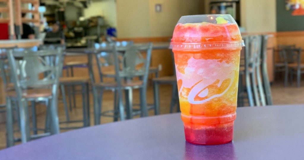 Taco Bell Cherry Sunset Freeze on table inside restaraunt