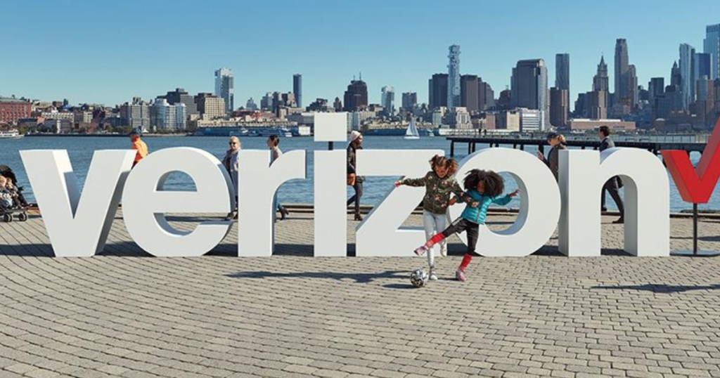 Kids playing near Verizon Sign