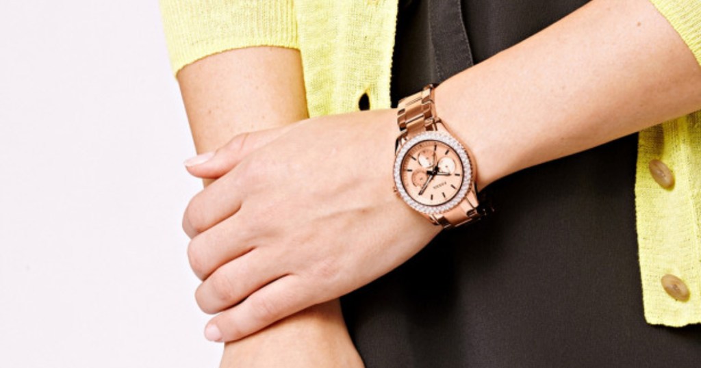 woman wearing rose gold fossil watch