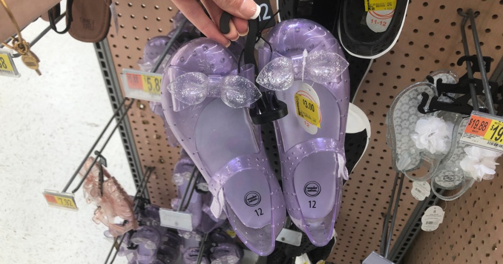 woman holding pair of wonder nation jelly shoes