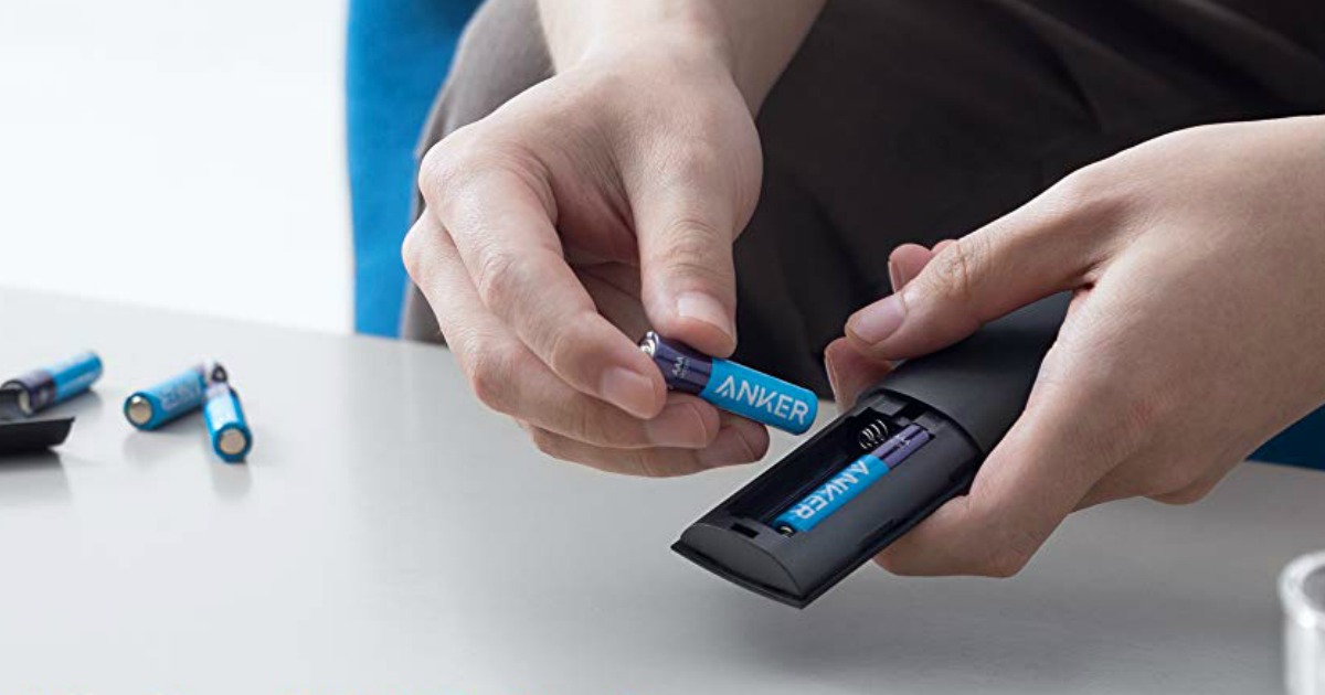 man replacing the batteries in a remote control