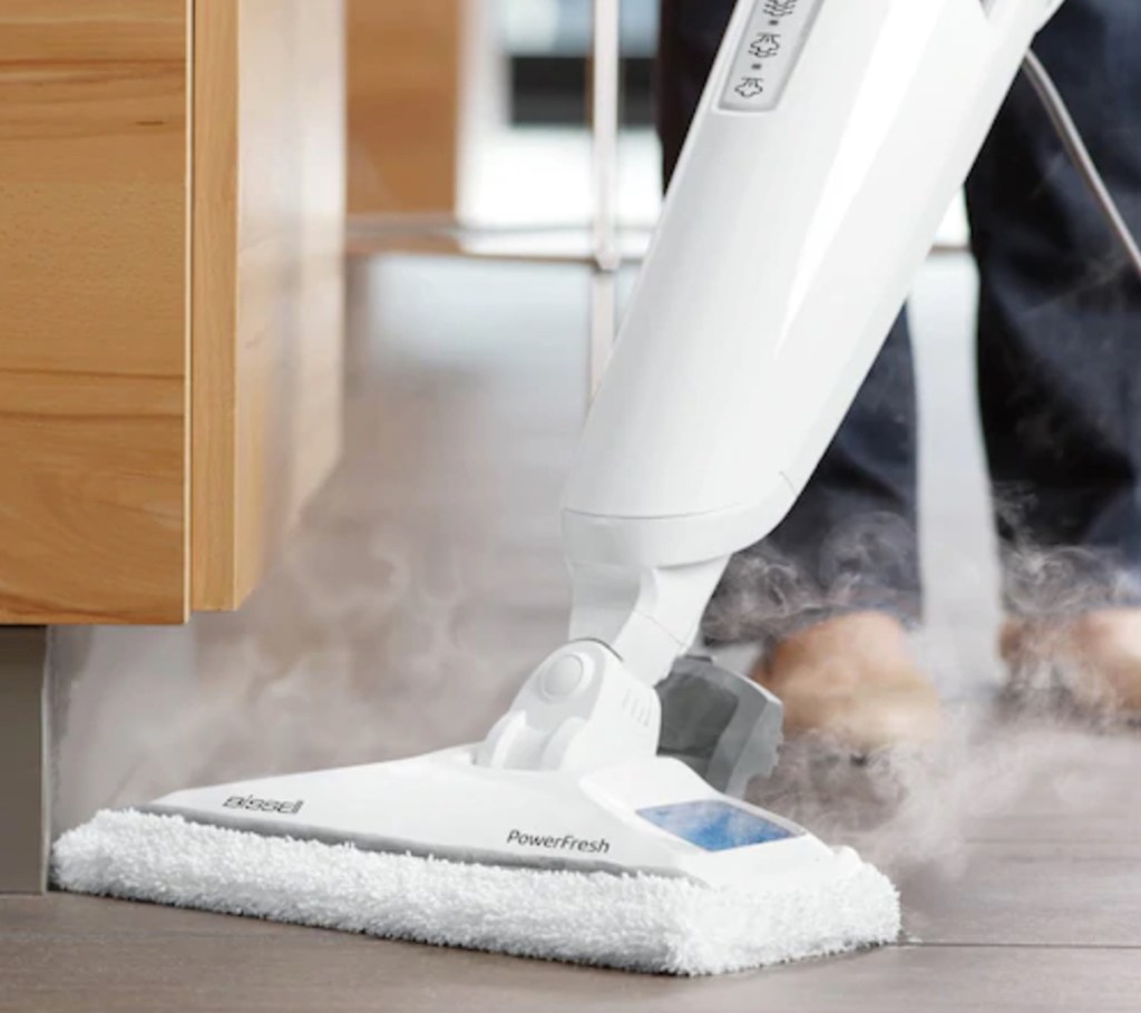 white steam mop cleaning and steaming floor 