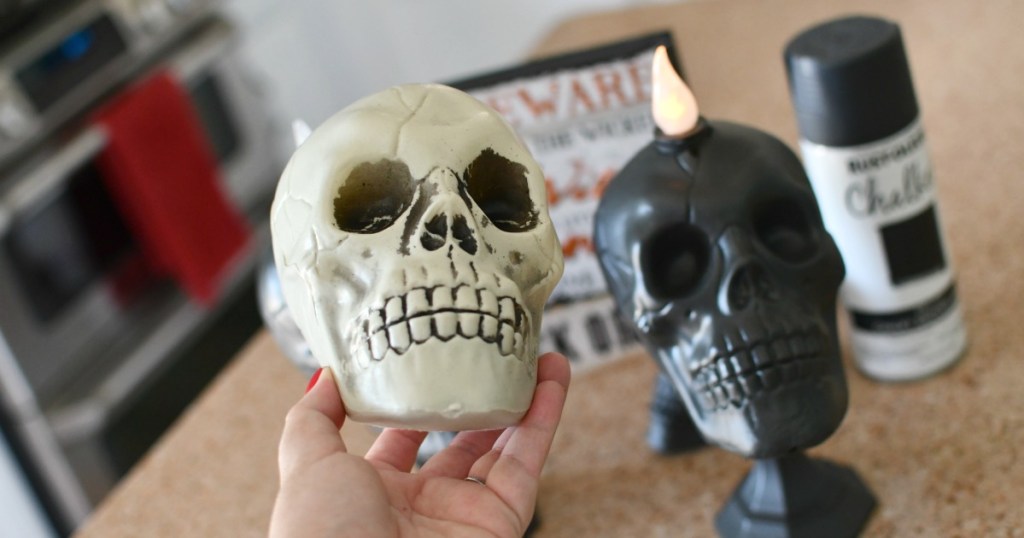 holding a dollar tree skull candlestick 