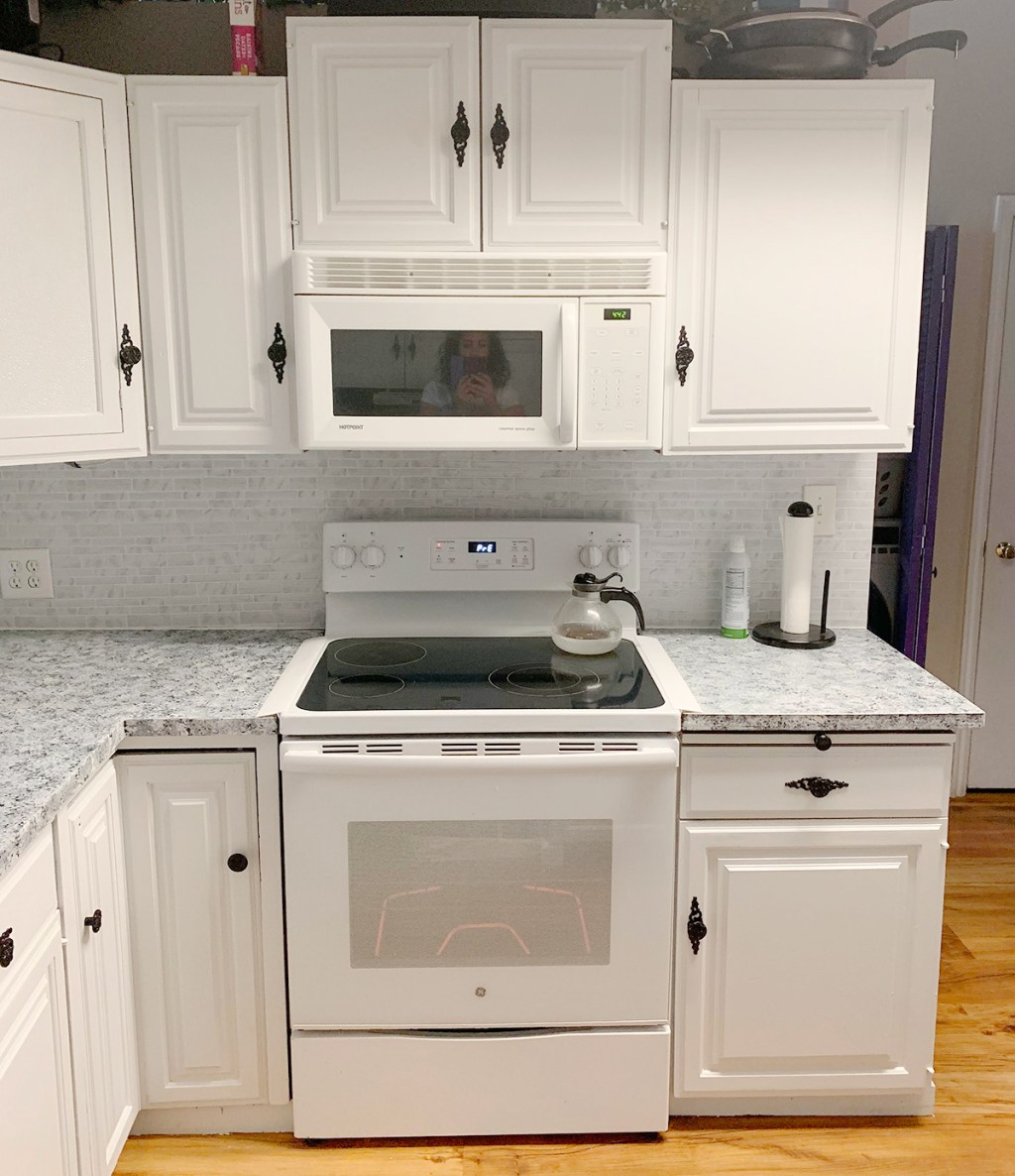 finished white cabinets and counters with newer appliances