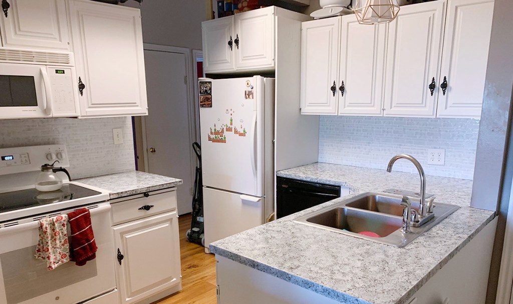 ktichen transformation after with white cabinets and refinished countertop