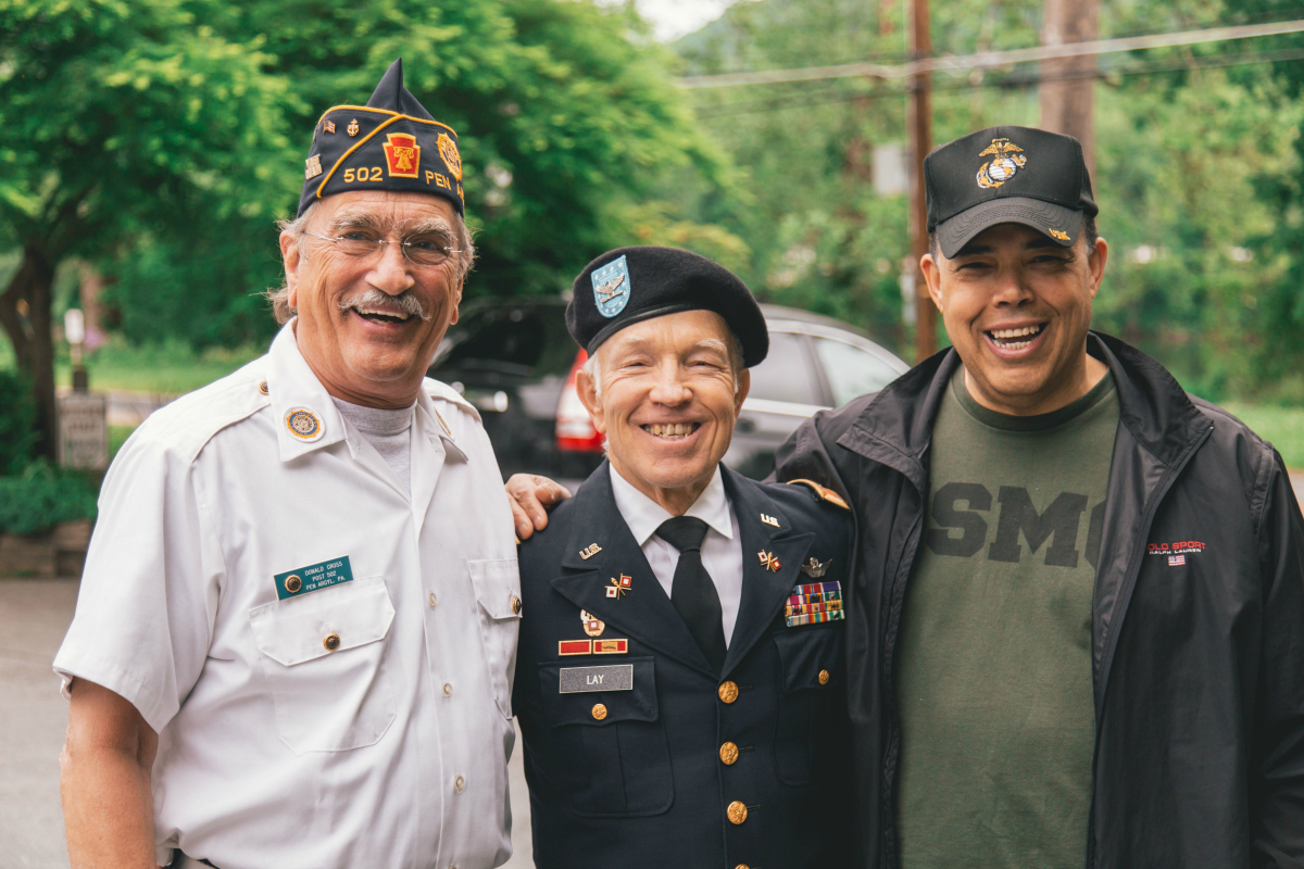 three military men standing side by side in uniform