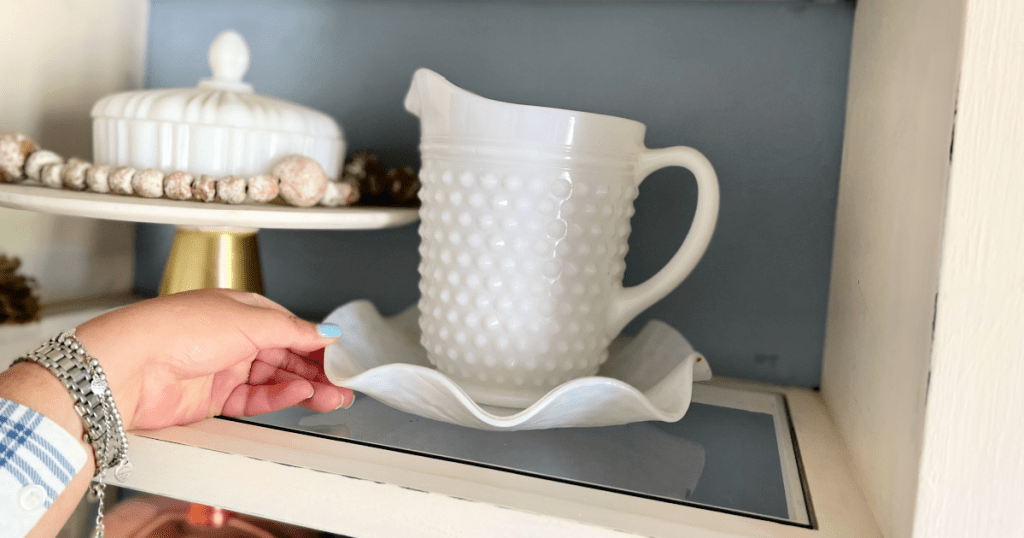 pieces of milk glass in a hutch .heic