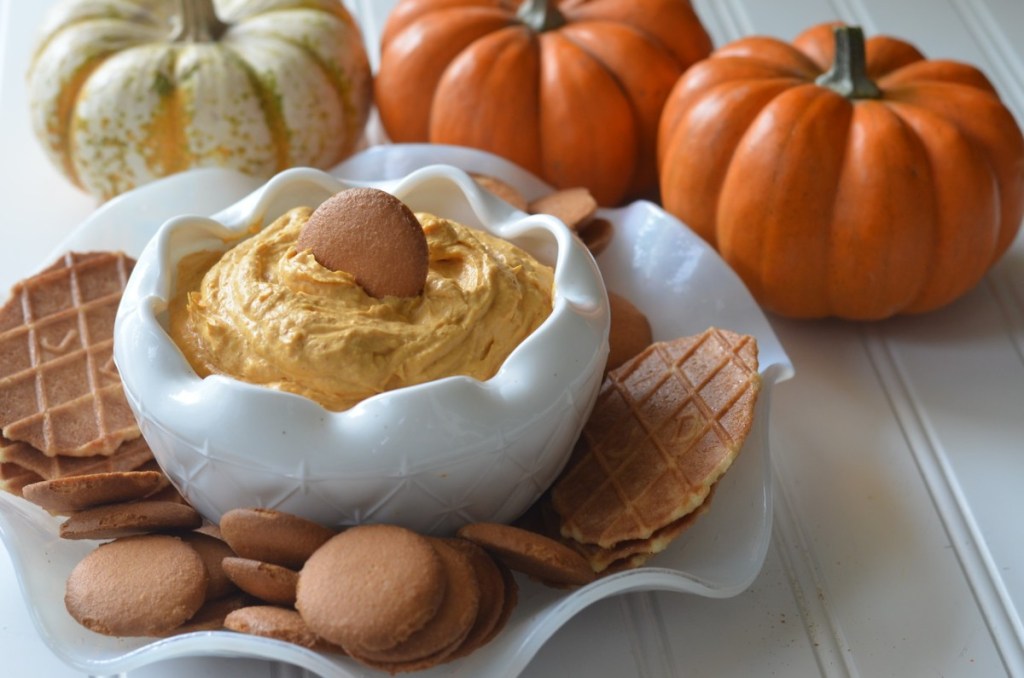 pumpkin pie dip on table with cookies and pumpkins