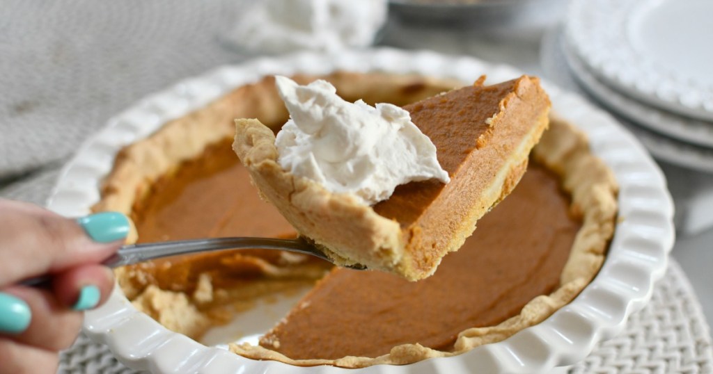 holding a slice of vegan pumpkin pie